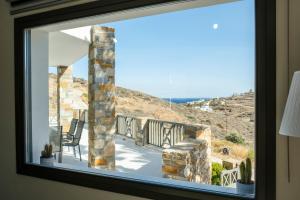 a window in a room with a view of a mountain at La vie en Abela in Megas Gialos - Nites