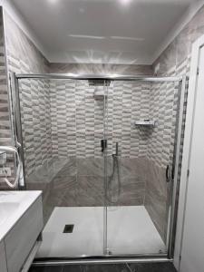 a shower with a glass door in a bathroom at Hotel Blanc in Casoria