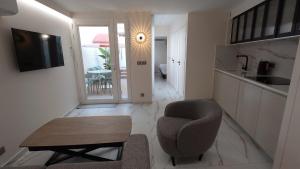 a living room with a chair and a table at Club Inn Appartement in Nice