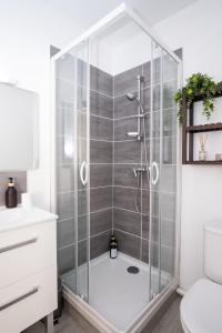 a shower with a glass door in a bathroom at Studio hyper centre au calme in Caen +39 photos