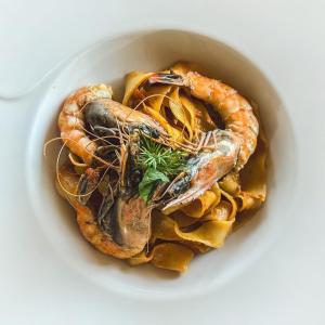 a bowl of food with shrimp and pasta at Cyprus Villages Hotel & Restaurant - Central Location - Bed & Breakfast - With Access To Pool And Stunning Views in Tochni