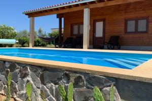 a swimming pool in front of a house at Quinta Pedro e Inês in Bragança