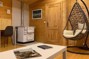 a room with a swing and a table with a book at Quinta Pedro e Inês in Bragança