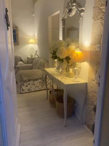 a room with a table with flowers and a mirror at Casita Boutique en la playa in Sant Antoni de Calonge +20 photos