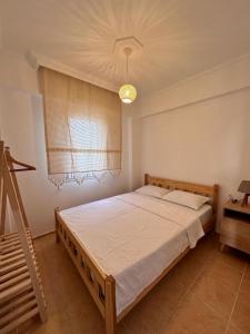 a bedroom with a bed and a chandelier at Wonderful Sunset in Turgutreis