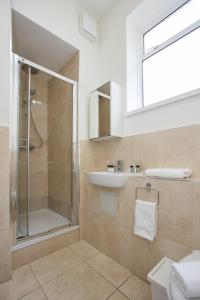 a bathroom with a shower and a sink at Temple Bar Essex Apartments in Dublin