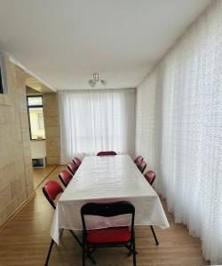 a conference room with a white table and red chairs at ЦО Diamond resort Иссык-Куль Киргизия in Bosteri