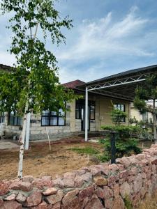 a stone wall in front of a building at ЦО Diamond resort Иссык-Куль Киргизия in Bosteri