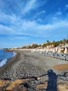 a shadow of a person standing on a beach at Appartement 3 PIECES NICE Promenade in Nice