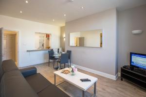 a living room with a couch and a table at Temple Bar Essex Apartments in Dublin