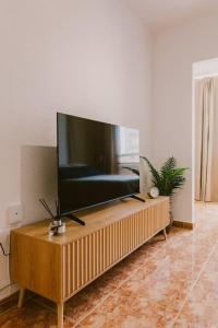a living room with a large flat screen tv on a table at Estudio en Torre del Mar a 3 minutos andando de la playa in Torre del Mar
