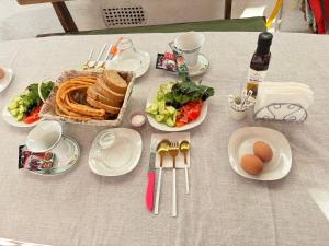 a table with plates of food and eggs on it at Hostel,halal in Tokmok