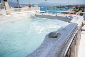a jacuzzi tub on a balcony of a building at Vip penthouse patra in Patra