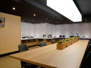 a conference room with a large wooden table and chairs at Comfort Inn Kyoto Shijokarasuma in Kyoto