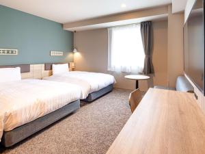 Postel nebo postele na pokoji v ubytování Comfort Hotel Takamatsu