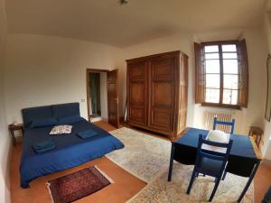 a bedroom with a bed and a table and chairs at Suite storica e panoramica - Centro in Pisa
