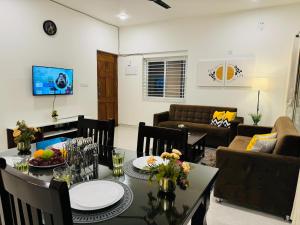 a living room with a table and a couch at Olive Serviced Apartments HSR Layout in Bengaluru