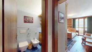 a bathroom with a toilet and a sink at Abitaziun St Moritzerhof 61 - St Moritz in St. Moritz +27 photos