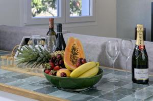 a bowl of fruit on a table with wine glasses at Comeback LA CASA OCULTA DE LA LUNA in Salobreña