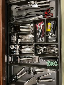 a drawer full of utensils in a refrigerator at FeWo Luise mit 4-Zimmer, Balkon, 127qm in Görlitz +8 photos