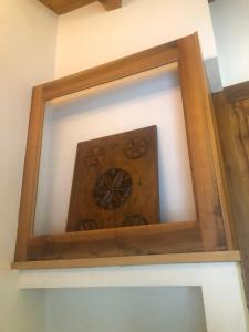 a mirror in a wooden frame on a wall at TROIS COURONNES - GRANDE ROCHERE Appartamento di Charme a La Salle Valle d'Aosta in La Salle
