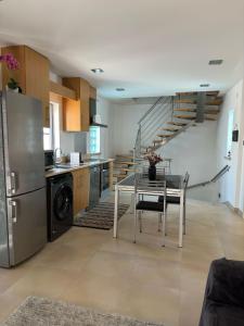 a kitchen with a table and a kitchen with a staircase at Ocean Breeze guesthouse in Nazaré +17 photos