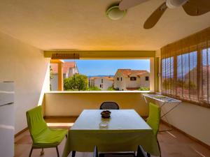 a room with a table and chairs and a large window at Apartments Panda in Bol