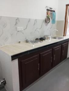 a kitchen with a sink and a counter top at Lilly Pilly Villa Arugambay in Arugam Bay
