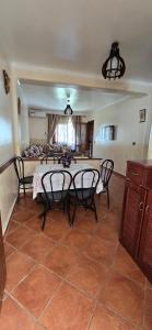 a dining room with a table and chairs in a room at Residence Lina in Cabo Negro