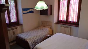 Кровать или кровати в номере La Pennica B&B