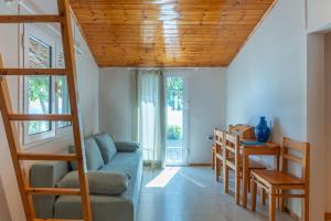 a living room with a couch and a table at Ionian Cape seaside apartment in Vrachos