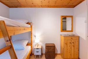 a bedroom with two bunk beds and a mirror at Ionian Cape seaside apartment in Vráchos