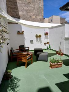 a patio with a couch and a table and chairs at Casa di max in Brindisi