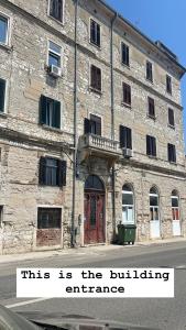 a building with a sign in front of it at Dejan apartment 3-Free parking near Arena in city center, near bus, train, ferry, airport shuttle in Pula