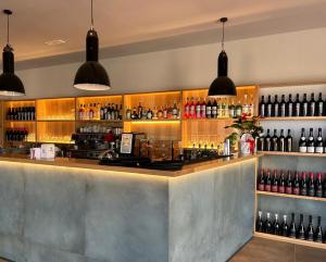 a bar with a lot of bottles of wine at Appartamento Calarossa Sardegna CasaRosa in Isola Rossa