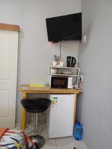 a kitchen with a microwave and a small refrigerator at WHY NOT GUESTHOUSE in Bothaville +24 photos
