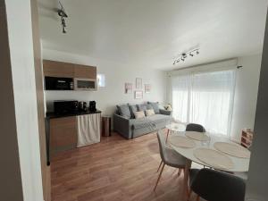 a living room with a table and a couch at Lovely Flat in Meaux