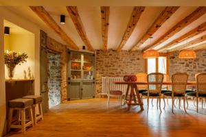 a dining room with a table and chairs at Masia la Oliva in Coll de Nargó