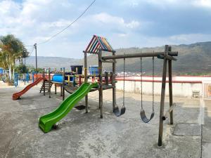 a playground with a slide and swings at Apartamento San Gil Amoblado in San Gil