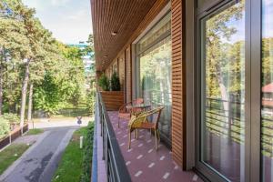 a balcony with a table and chairs on a house at Amber SPA Boutique Hotel in Jūrmala