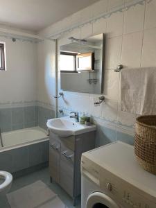 a bathroom with a sink and a tub and a toilet at VillaGer in Kalamata +12 photos