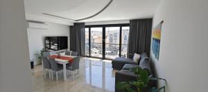 a living room with a couch and a dining room at Luxury Sea Front at Spinola Bay St Julians in St Julian's +26 photos