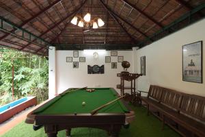 a room with a pool table and a ceiling at Vintage valley Heritage home in Thodupuzha