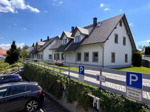 a row of houses with parking signs in front of them at Ferienhaus Papstdorf Sächsische Schweiz 18 in Kurort Gohrisch