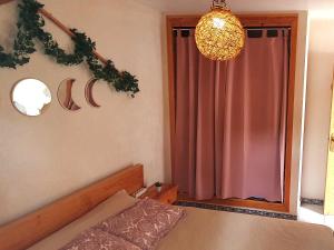 a bedroom with a bed and a chandelier at Apartamento en Sierra de Irta Peñiscola Font Sol 4 in Peñíscola