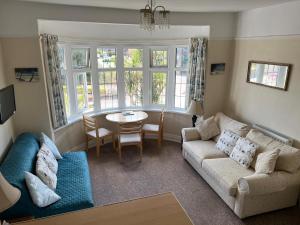 a living room with a couch and a table at San Remo in Paignton