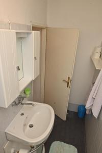 a bathroom with a white sink and a mirror at Guesthouse Klaric in Rovinj +32 photos