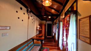 a hallway in a house with a room with windows at Longtail Beach Resort in Thong Nai Pan Yai