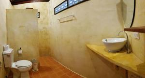 a bathroom with a sink and a toilet at Longtail Beach Resort in Thong Nai Pan Yai