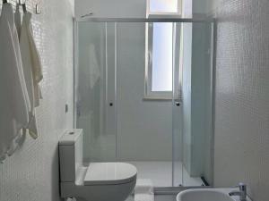 a bathroom with a shower and a toilet and a sink at Comfy Room near Metro & Airport in Lisbon